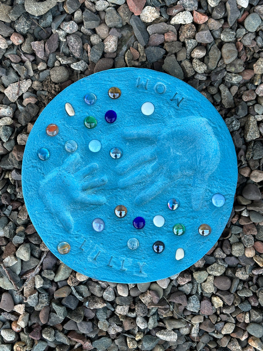 Colored stepping stones displayed over garden stone.  Colors include red, blue, green, gray, orange, and yellow.  Pick your color and have fun! 