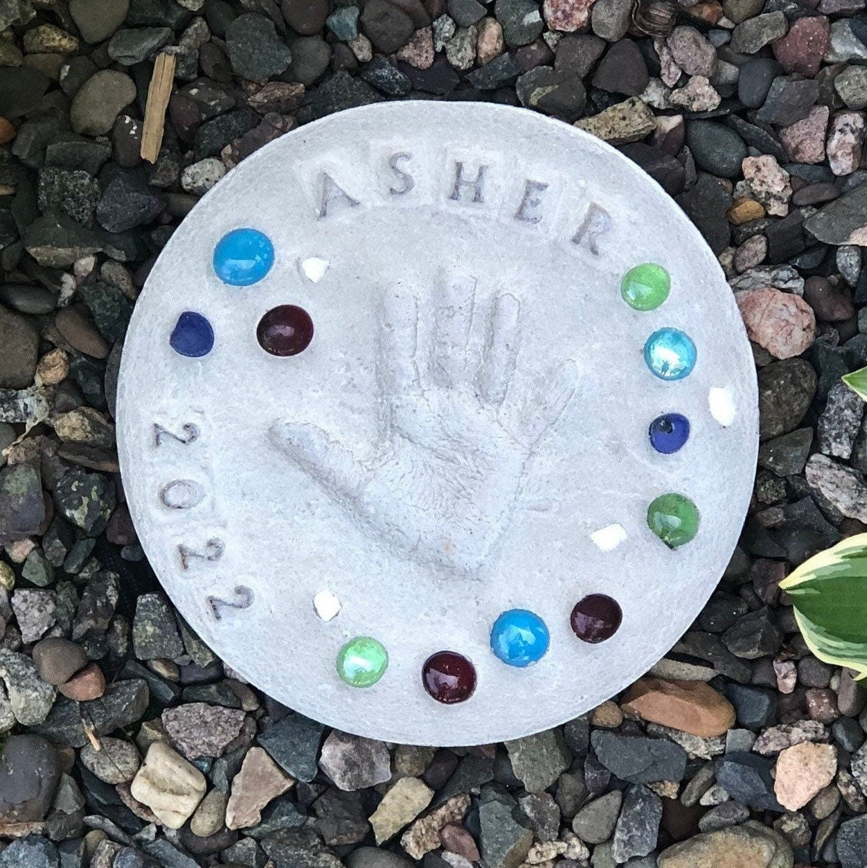 DIY stepping stone kit displayed on rock garden